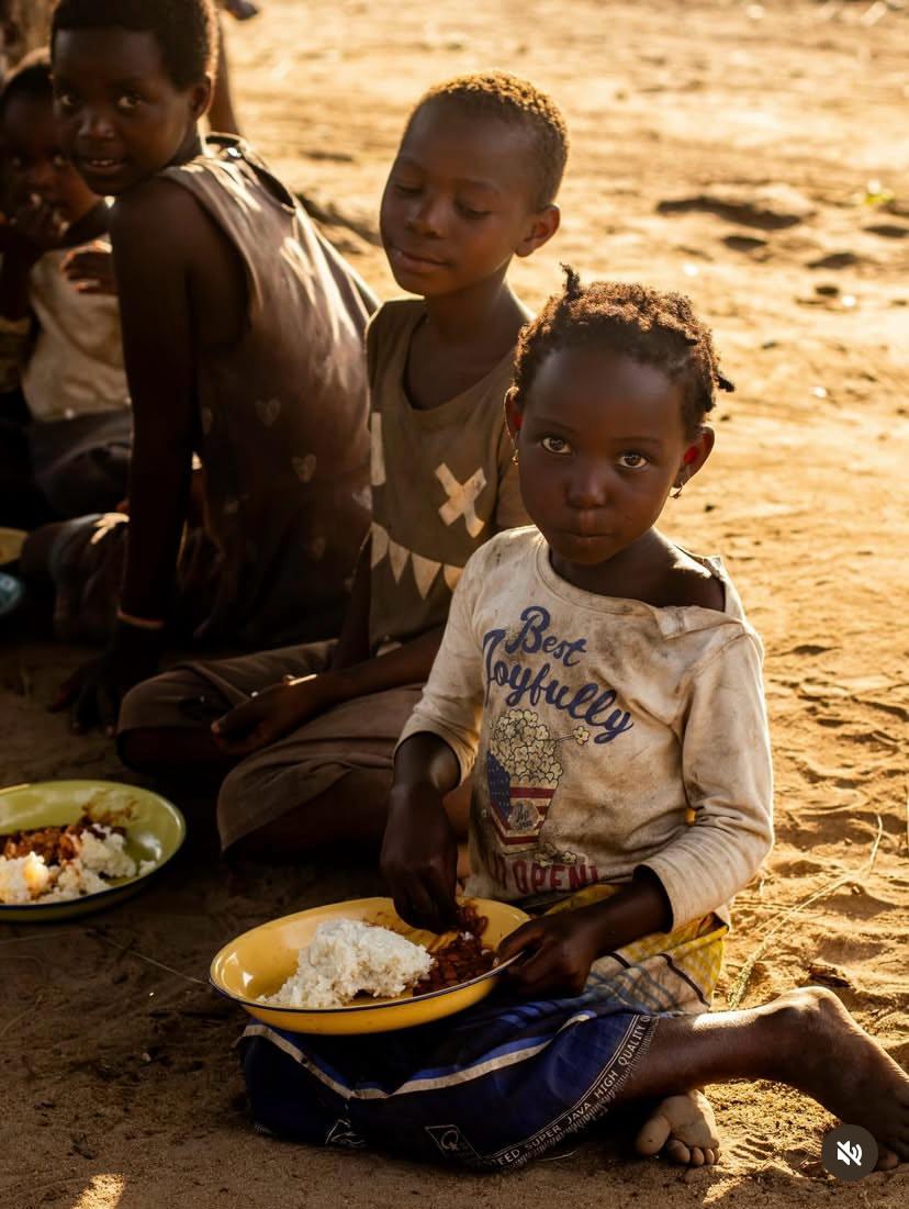 Refugee girl feeding